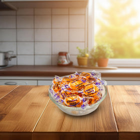 Individually wrapped butterscotch candies on a kitchen counter