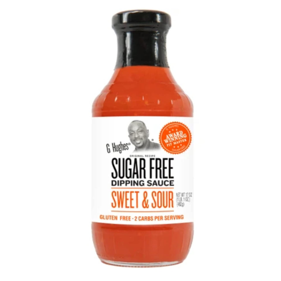 G Hughes sugar free Sweet & Sour sauce poured from a glass bottle, ideal for dipping.