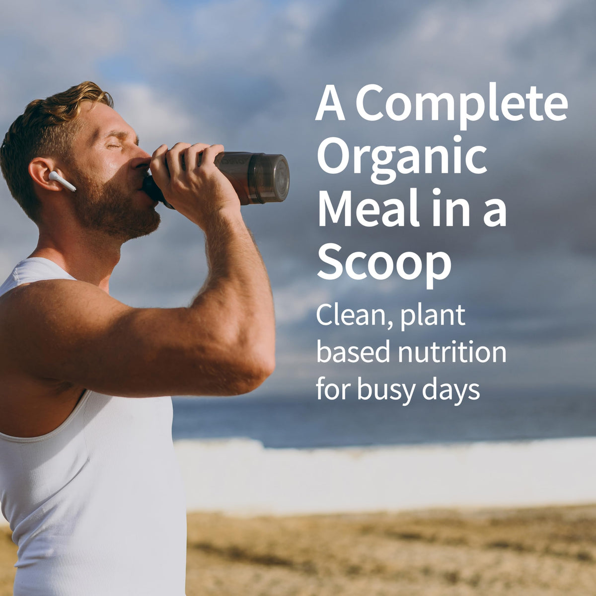 Garden of Life Raw Organic Meal powder scoop beside a glass of water for quick shakes.