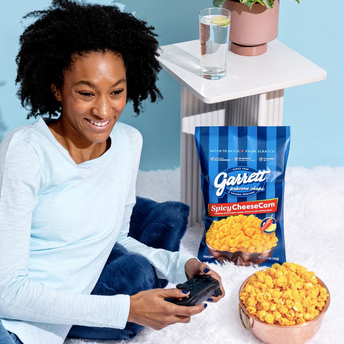 Garrett Popcorn Spicy CheeseCorn on a table for game night snacking.