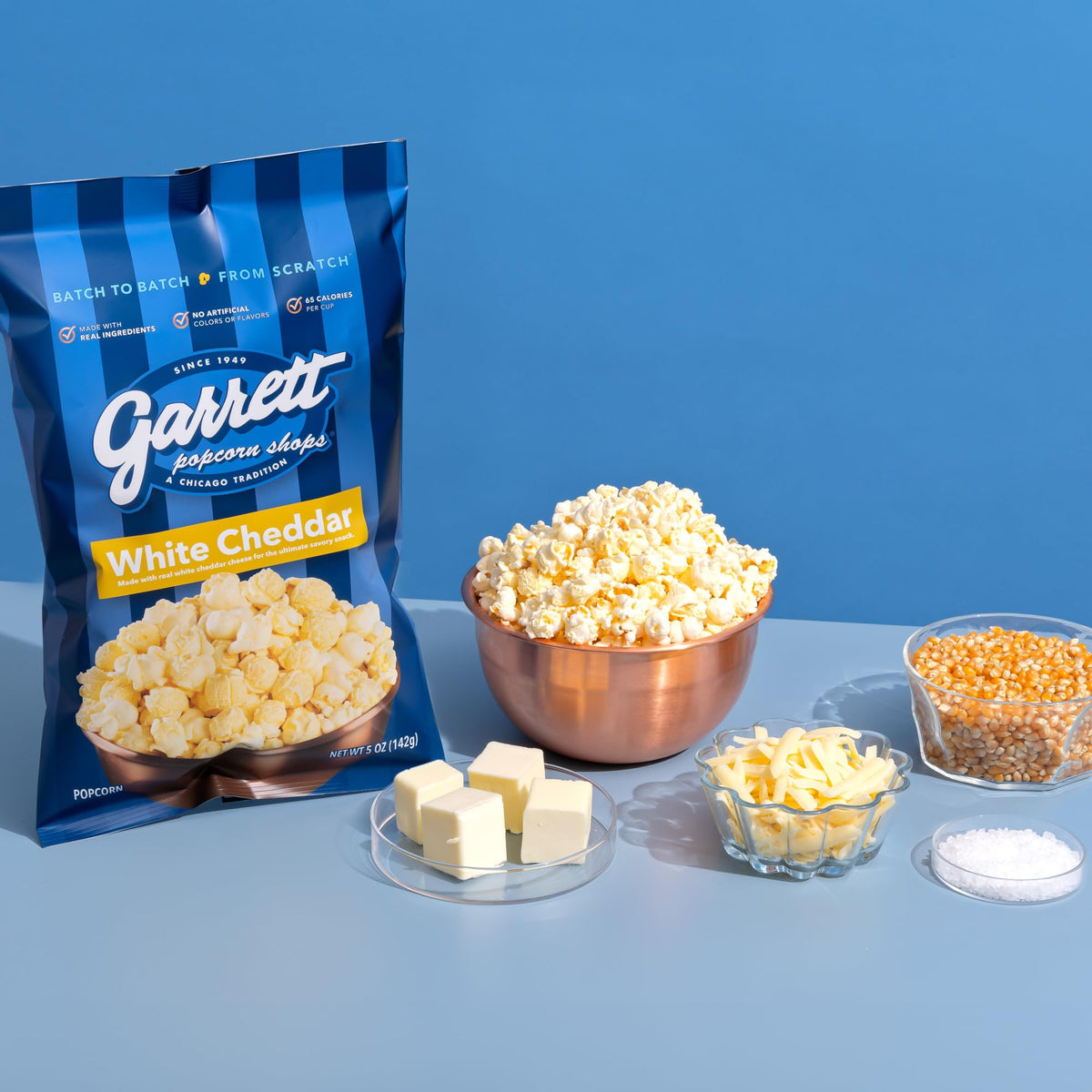 Gift-ready Garrett Popcorn White Cheddar box with ribbon.