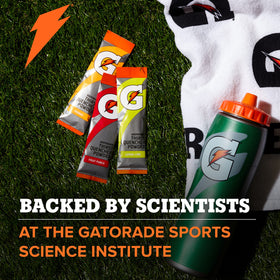 Pouring orange Gatorade into a glass after a workout