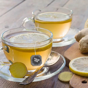 Brewing moment with Generic Bigelowwss Lemon Ginger Tea releasing citrus fragrance.