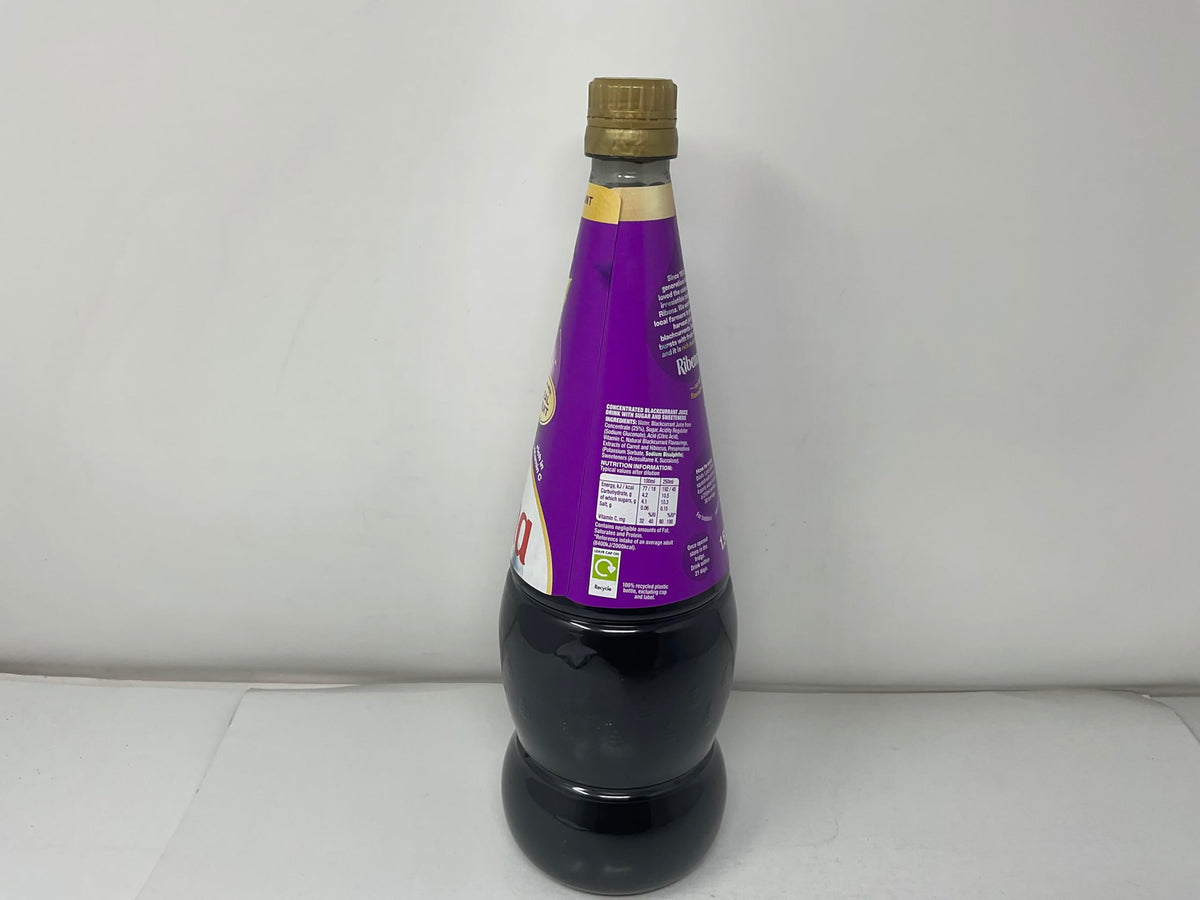 Generic blackcurrant concentrate bottle pouring to measure precise amounts.
