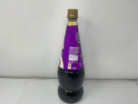 Generic blackcurrant concentrate bottle pouring to measure precise amounts.