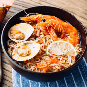 Generic MAMA shrimp tom yum broth swirling with noodles, ready in minutes.