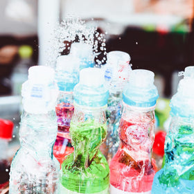 Generic Ramune strawberry bottles at a party setting, ideal for themed treats.