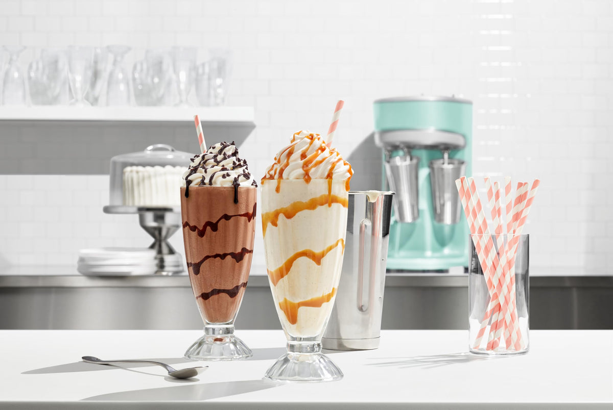 Ghirardelli latte topping with caramel swirl demonstrates refined beverage enhancement.