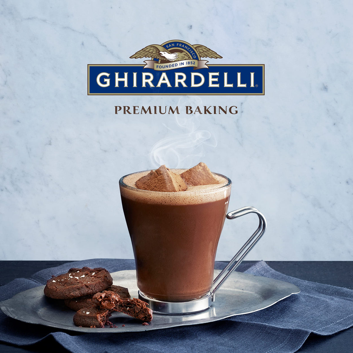 Pouring Ghirardelli cocoa into warm milk for a silky drink.