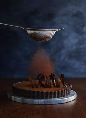 Ghirardelli Majestic Dutch Cocoa Powder close-up shows deep color and aroma