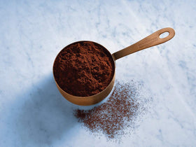 Ghirardelli Majestic Dutch Cocoa Powder scoop ready for baking and confections