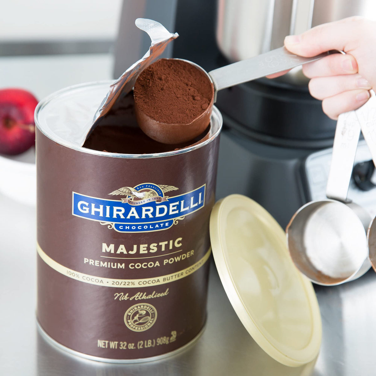 Ghirardelli Majestic Premium Cocoa Powder poured into bowl for rich batter