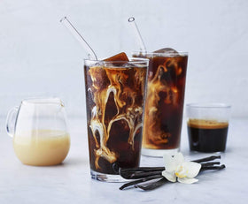 Ghirardelli Vanilla Sauce pouring with a silky, creamy texture for beverages.