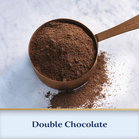 Whipped cream topping on a cup of Ghirardelli hot cocoa