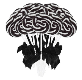 Gift Boutique black and white swirl lollipops on a plate for an elegant party display and guest candy table.