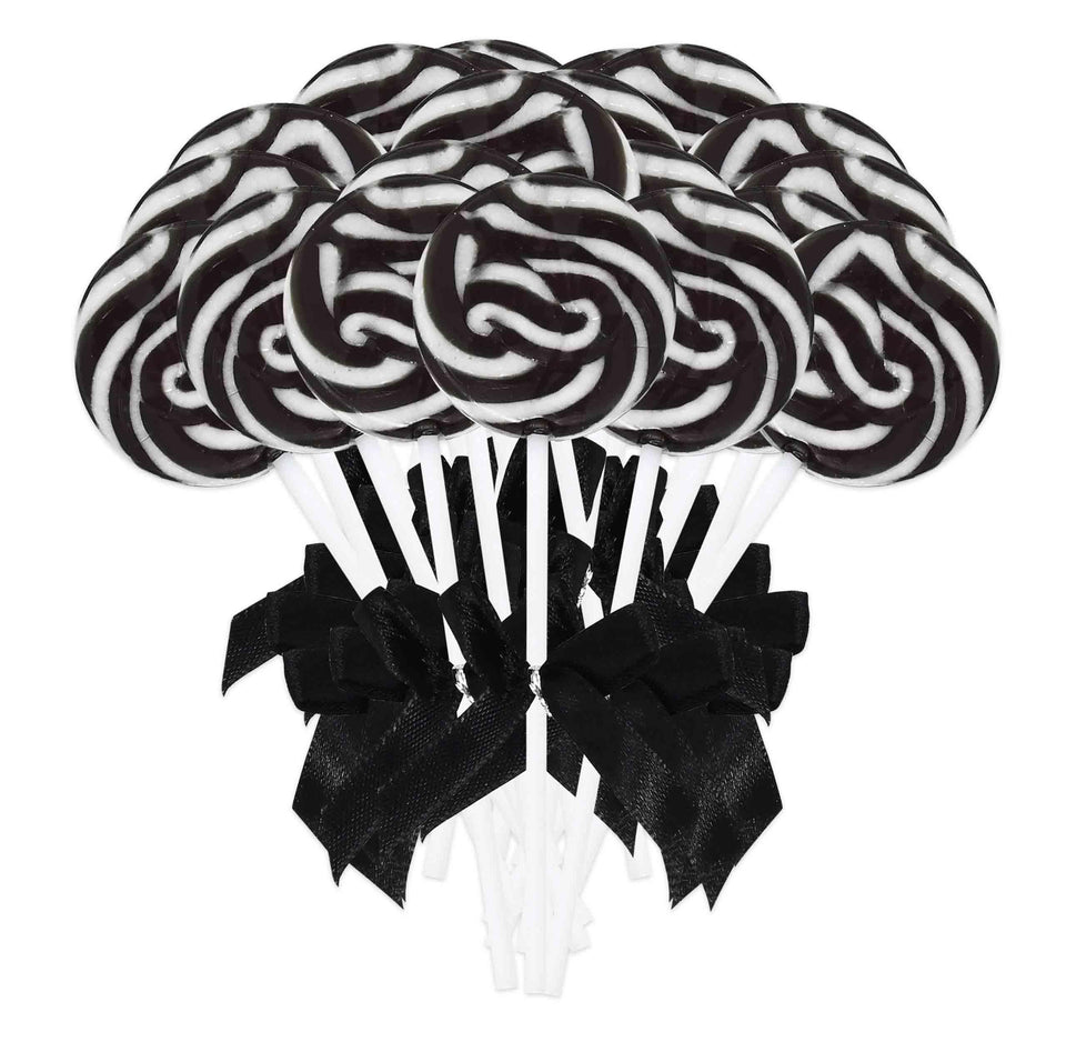 Gift Boutique black and white swirl lollipops on a plate for an elegant party display and guest candy table.