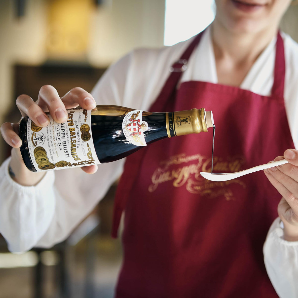 Barrel aging scene for Giusti balsamic highlights traditional refinement.
