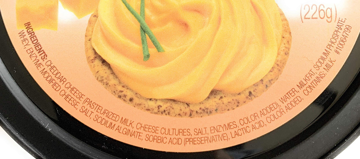 Glacier Ridge Farms Aged Cheddar Spreadable Cheese on a cheese board for quick entertaining