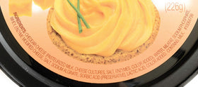Glacier Ridge Farms Aged Cheddar Spreadable Cheese on a cheese board for quick entertaining