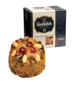 Glenfiddich malt whisky bottle beside cake suggests luxurious pairing.