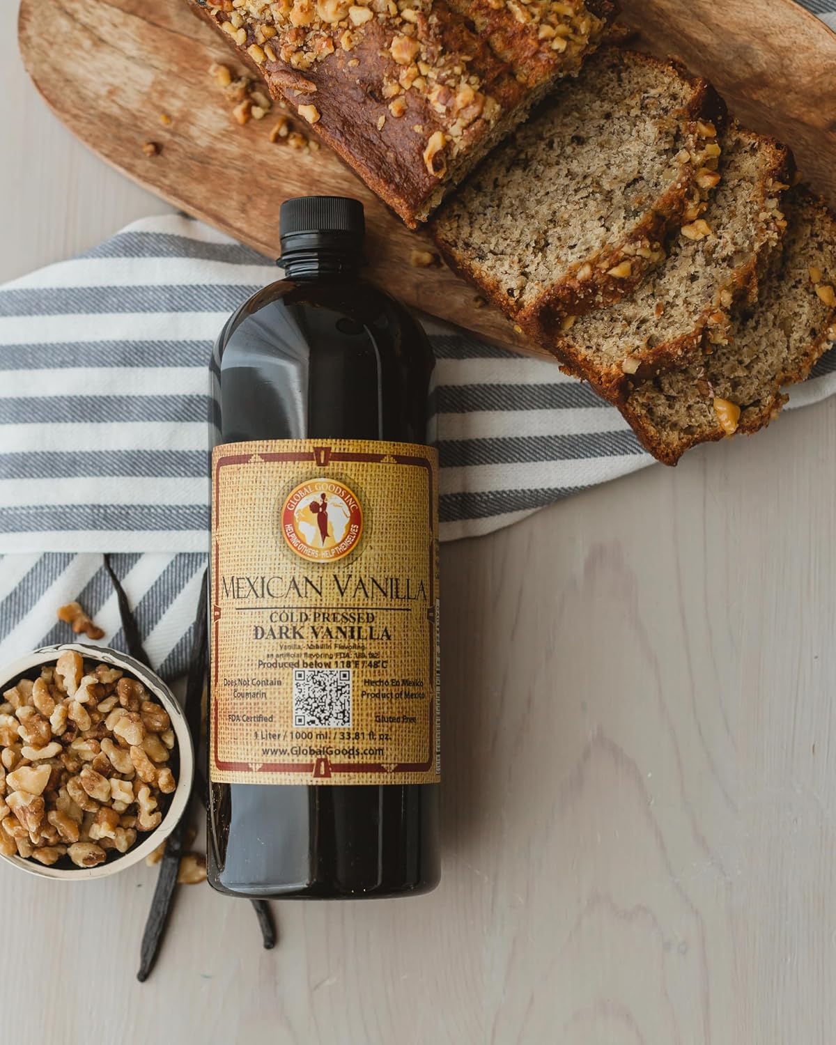 Global Goods vanilla bottle pouring, showcasing smooth flavor ideal for cookies and cakes.