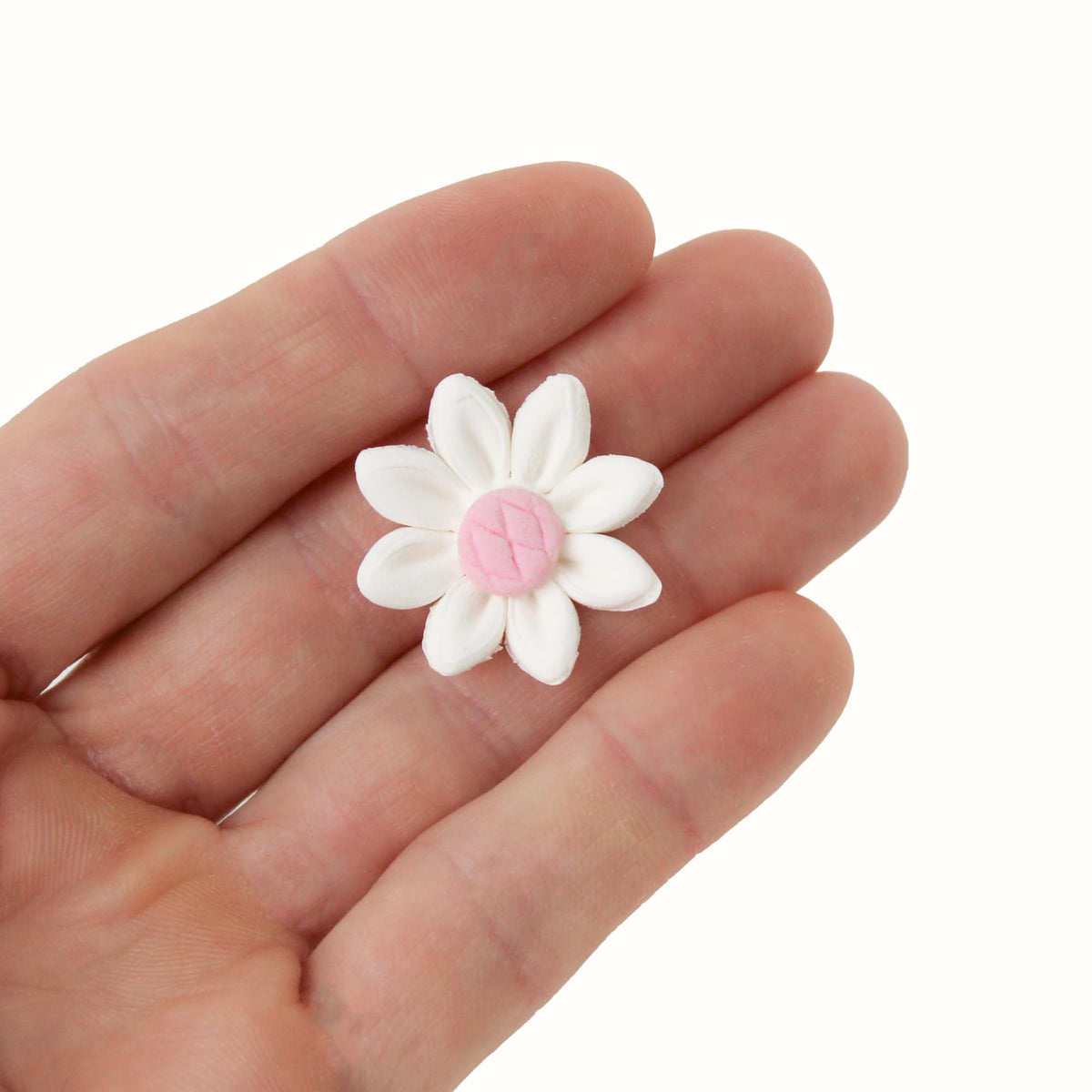 Global Sugar Art white and pink daisies decorate cakes with edible charm.