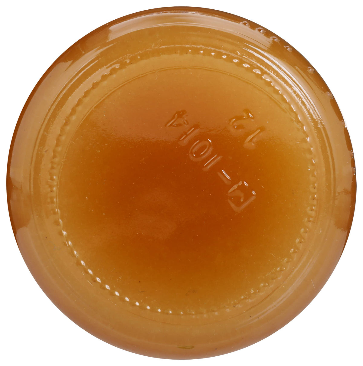 Close-up of amber GloryBee honey drizzle on bread or fruit