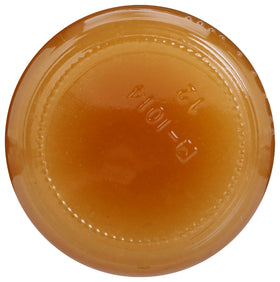 Close-up of amber GloryBee honey drizzle on bread or fruit