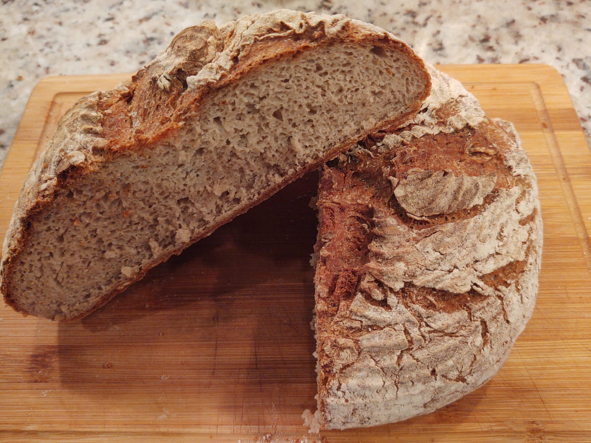 Glutenfreeee crusty loaf baked to a golden, crispy exterior.