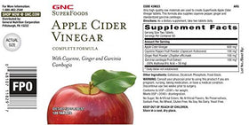 GNC SuperFoods Apple Cider Vinegar bottle next to glass demonstrating suggested serving