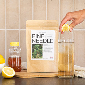 Go Natural Pine Needle Tea brewed cup with steam, conveying daily ritual and wellness.