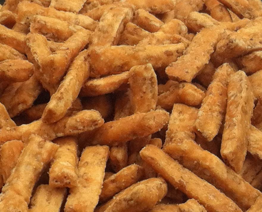 Golden Flavor Sesame Sticks unsalted packaging showing four 12-ounce bags for convenient snacking.