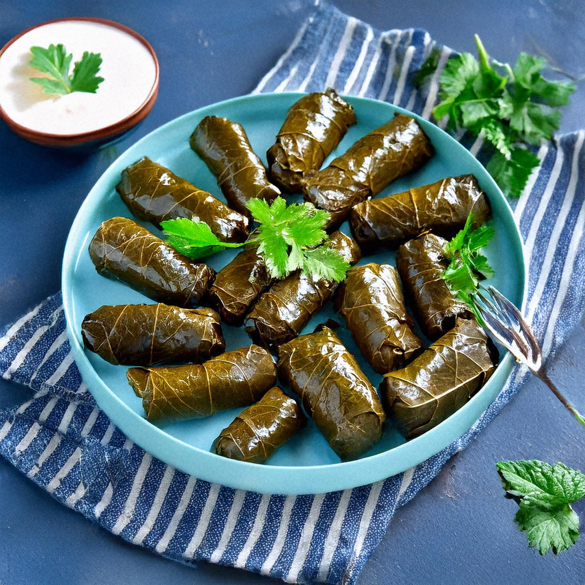 Golden Harvest dolmas wrapped in grape leaves with fresh herbs.
