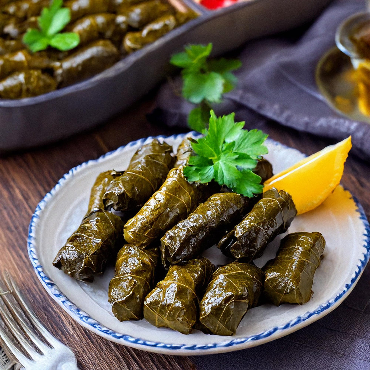 Serving bowl of Golden Harvest dolmas highlighting olive oil sheen.