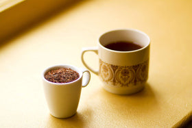 Golden Moon Rooibos steeping beside a kettle suggests a relaxing ritual