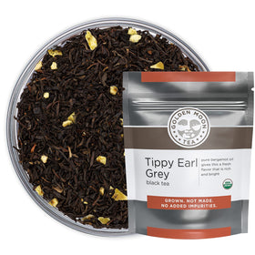Golden Moon Tea Earl Grey loose leaf in a cup with fragrant aroma.