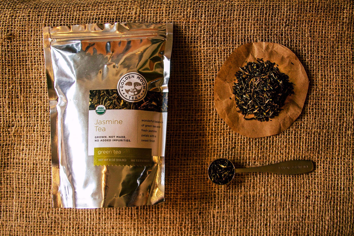 Golden Moon Tea jasmine-steeping in a teapot releasing delicate fragrance