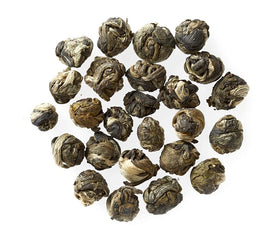 Golden Moon Tea Organic Green Tea Leaves closeup emphasizes pure, GMO-free leaves for clean flavor.