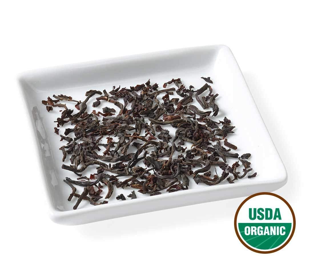 Golden Moon Tea quality-assurance badge highlights purity and care.