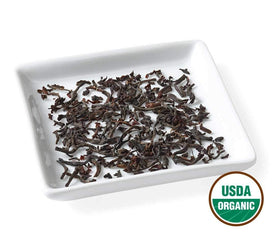 Golden Moon Tea quality-assurance badge highlights purity and care.