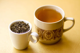 Golden Moon Tea steam rising from a cup with soothing jasmine aroma