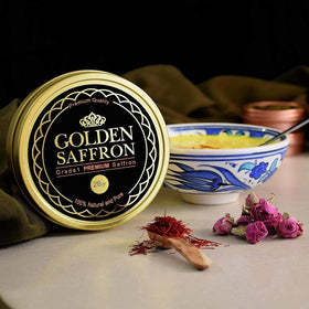 Golden Saffron tea infusion with saffron strands steeping in cup.