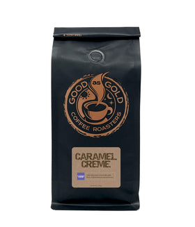 Good As Gold Caramel Cream coffee cup steaming to showcase inviting aroma.