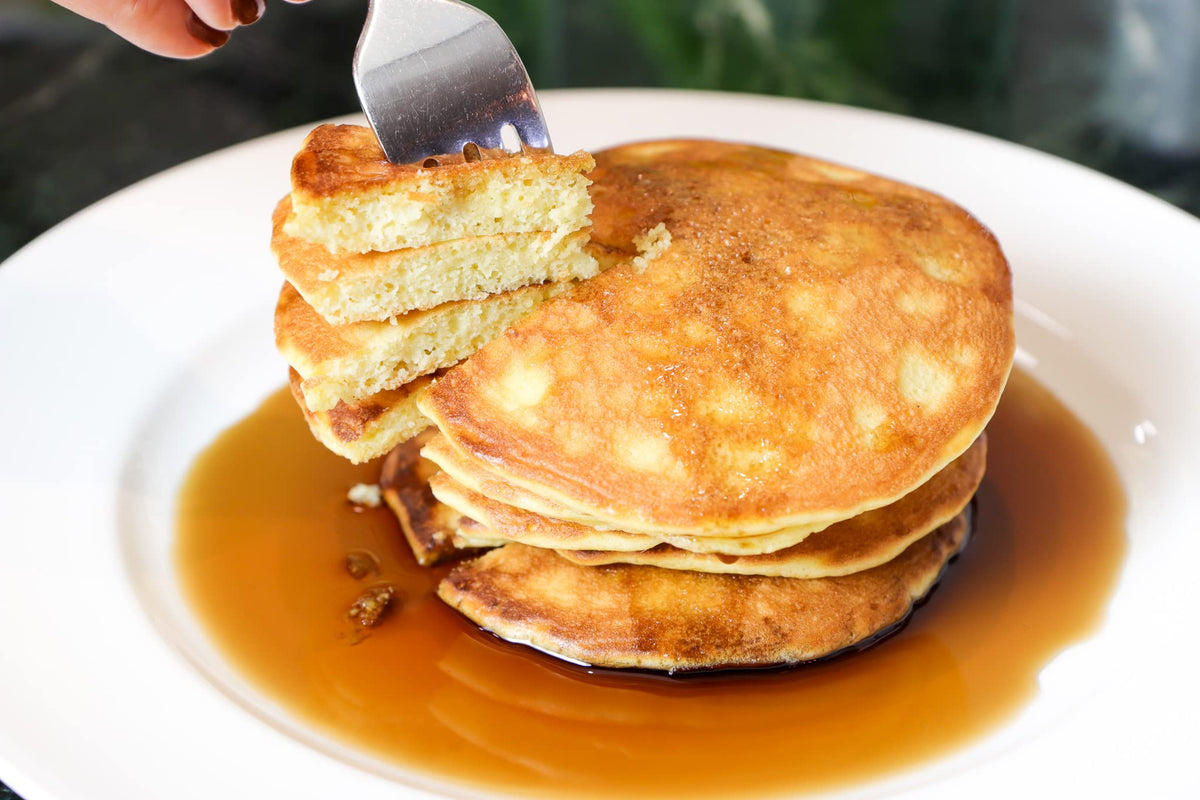 Golden waffles prepared with Good Dee’s Pancake Mix on a plate.