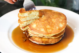 Golden waffles prepared with Good Dee’s Pancake Mix on a plate.