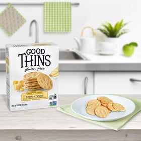 Good Thins crackers beside a steaming bowl of soup.