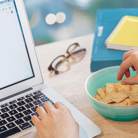 Good Thins crackers beside salads and sandwiches for crunch