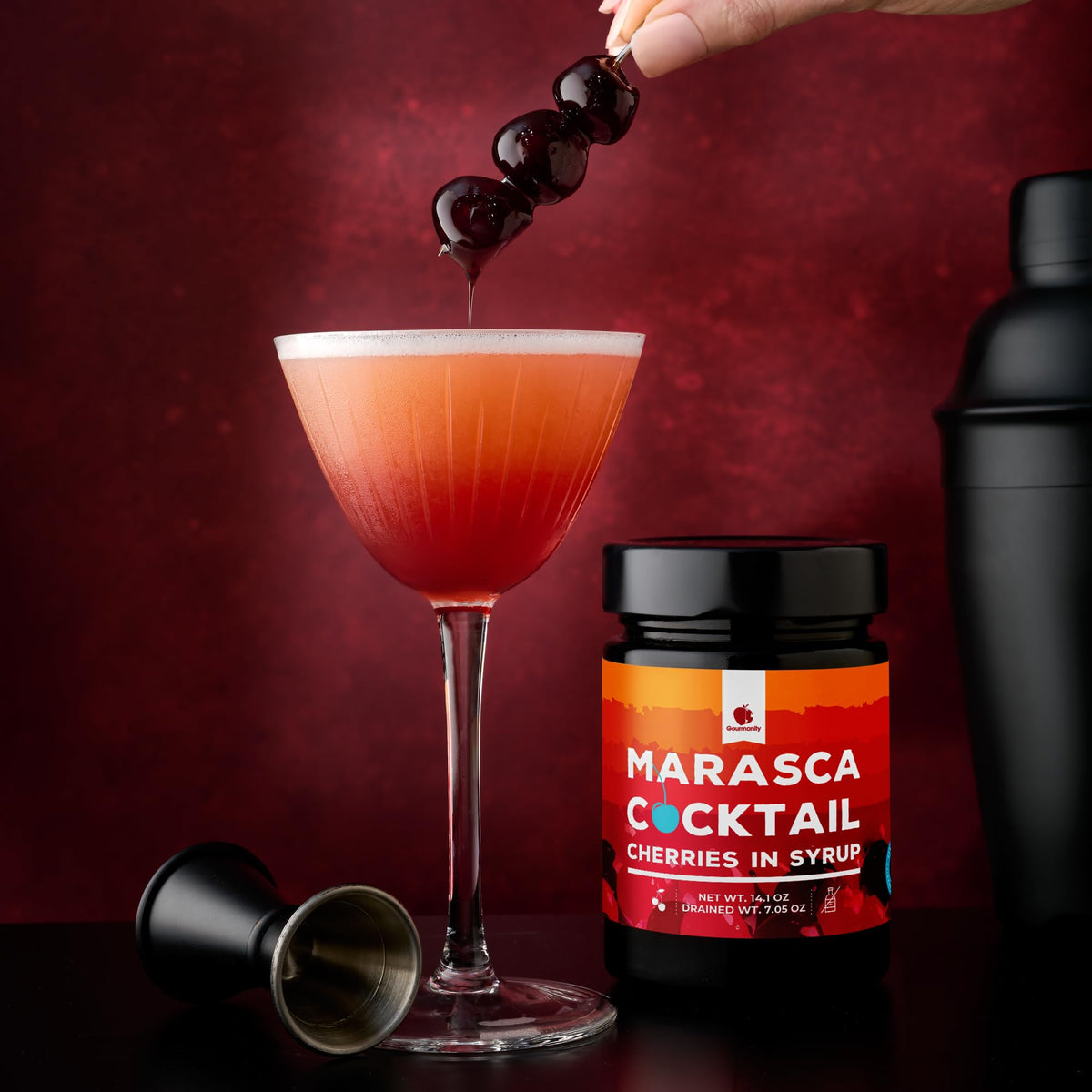 Gourmanity cherry garnish atop a sleek cocktail for a refined finish.