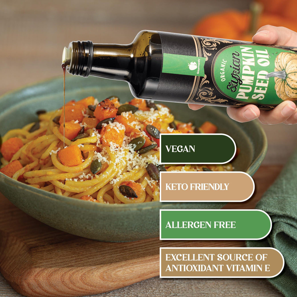 Gourmanity Styrian pumpkin seed oil being poured over a fresh salad.