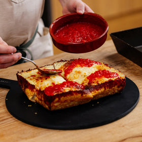 Gozney Detroit dough in oven, highlighting high-heat cooking for crisp edges.
